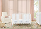 White crib in a nursery with pink walls, chair, and dresser. 15-Lulu 5-in-1 Convertible Crib