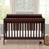 Wooden crib in a nursery with a window and decorative wall in the background 36-Canton 4-in-1 Crib