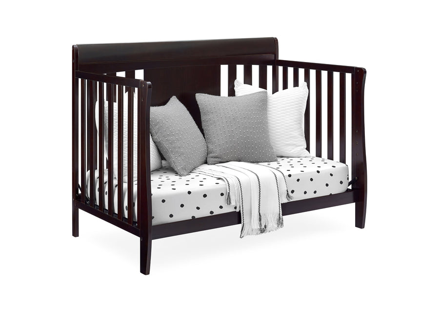 Wooden crib with pillows and a blanket on a white background 11-Richmond 6-in-1 Convertible Baby Crib