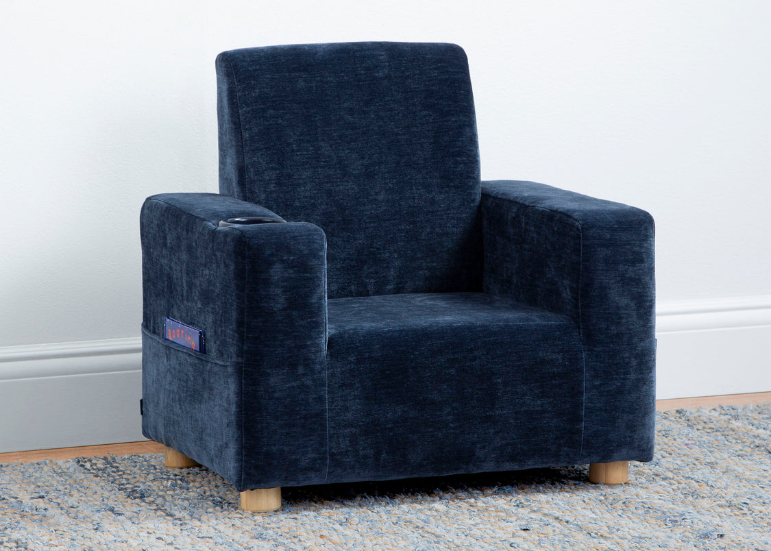 Blue armchair on a light gray rug with a white wall background