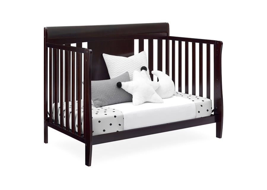 Wooden crib with white bedding and decorative pillows on a white background 14-Richmond 6-in-1 Convertible Baby Crib
