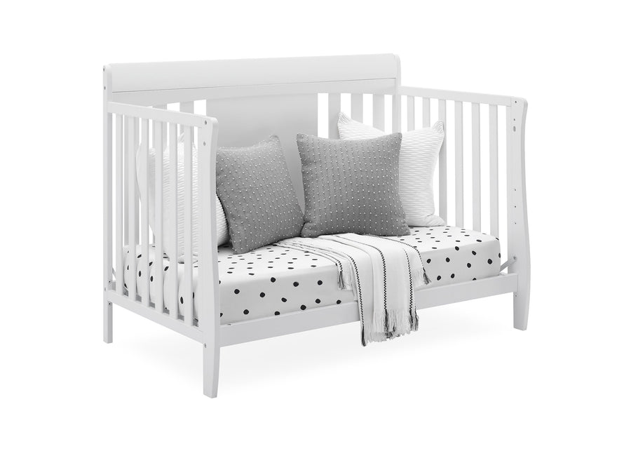 White crib with gray pillows and a polka dot blanket on a white background 22-Richmond 6-in-1 Convertible Baby Crib
