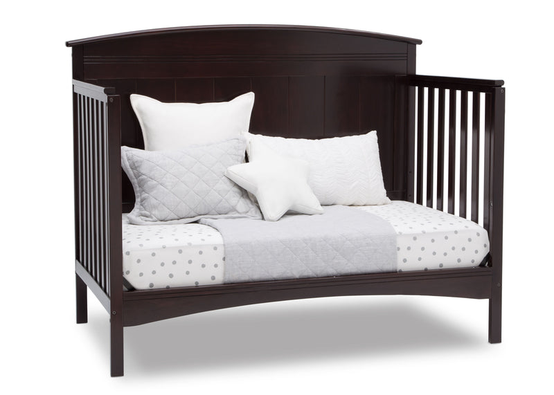 Dark wood crib with white bedding and pillows on a white background 22-Archer 4-in-1 Convertible Crib