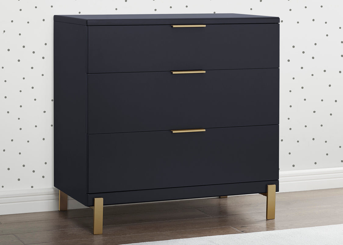 Navy blue dresser with gold legs and handles against a white wall with black dot pattern