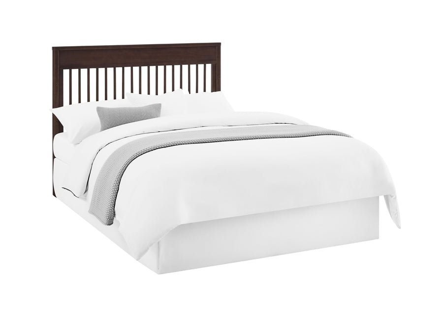 Bed with white bedding and a dark wood headboard on a white background 10-Remy 6-in-1 Convertible Crib