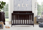 Nursery room with a dark wood crib, dresser, and decorative elements. 16-Richmond 6-in-1 Convertible Baby Crib
