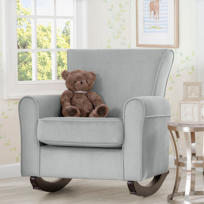 Gray rocking chair with a teddy bear in a room with a window and framed picture on the wall. 0-Lancaster Rocking Chair featuring LiveSmart Fabric by Culp