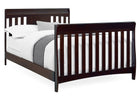 Dark wood crib with white bedding on a white background 12-Richmond 6-in-1 Convertible Baby Crib