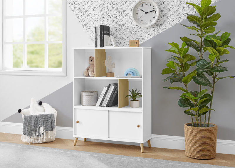 White bookshelf with decorative items in a room with a plant and clock on the wall. 14-Essex Bookcase