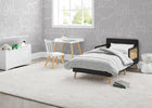 Children's bedroom with a bed, table, and chair against a gray wall with white line art. 7-Logan Wood Toddler Bed