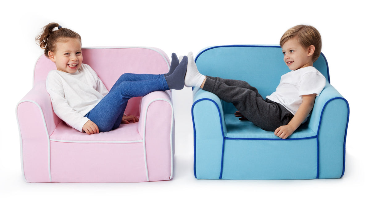 Two kids in armchairs touching feet