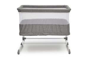 Back view of the baby bassinet showing mesh sides and grey fabric with white metal frame.